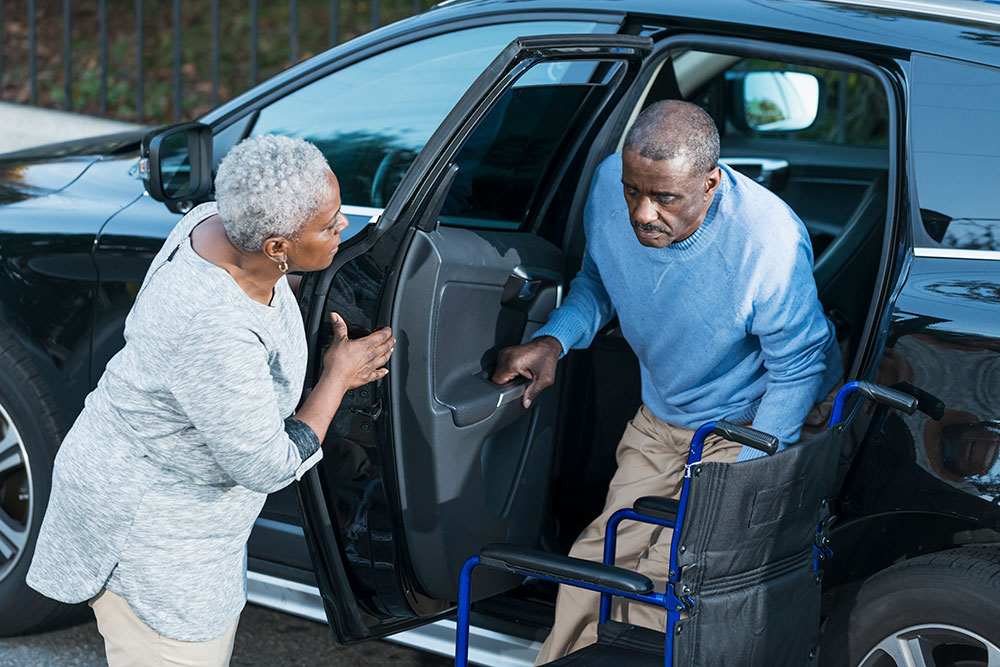 caretaker and man getting out of car