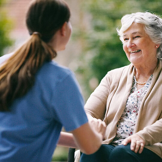 happy elderly woman and caretaker